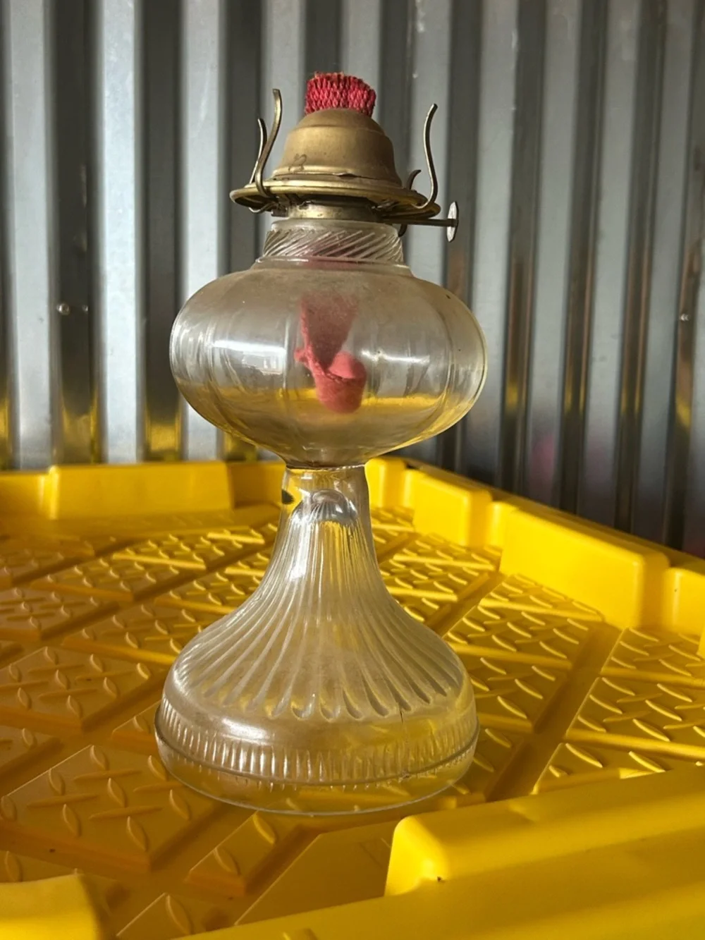 vintage clear glass kerosene oil lamp features a bulbous font and a ribbed base